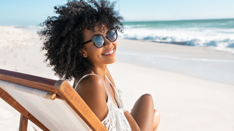 Woman smiling and lounging at the beach