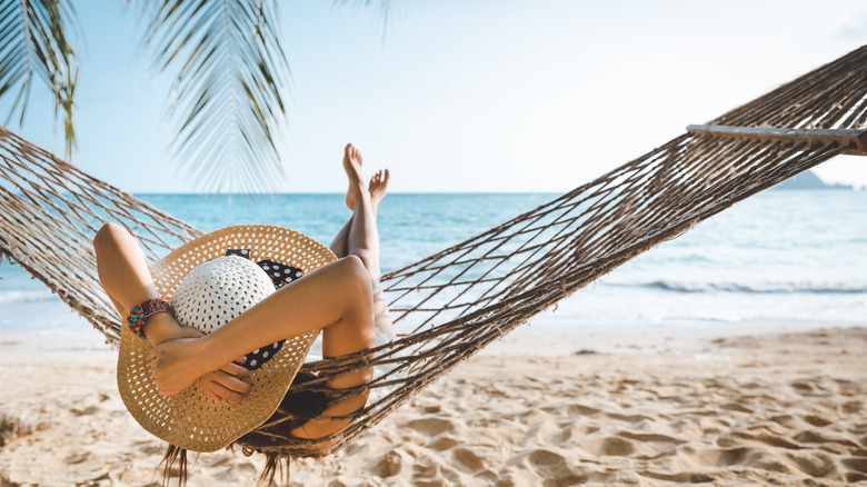 Solo traveler in hammock at the beach