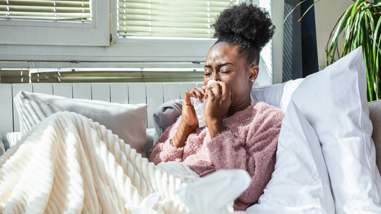 Woman blowing her nose
