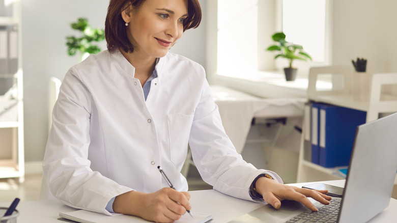 Doctor in white coat at desk