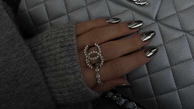 woman's hand with silver metallic nails
