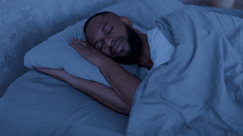 Man asleep in bed