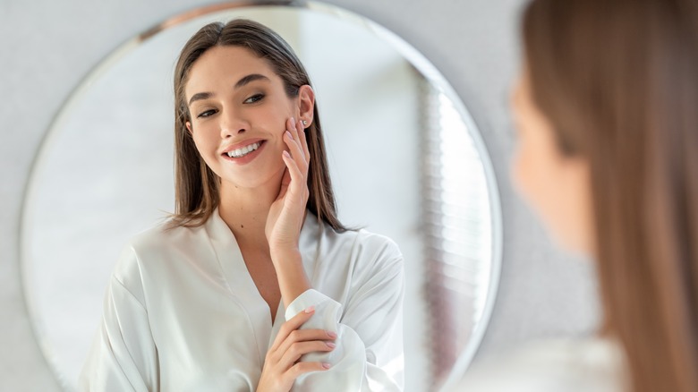 woman looking in the mirror