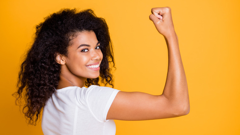 Woman flexes arm
