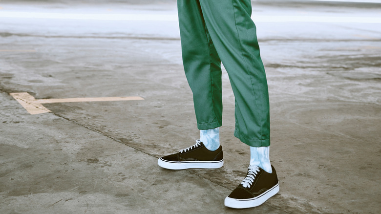 person wearing black sneakers