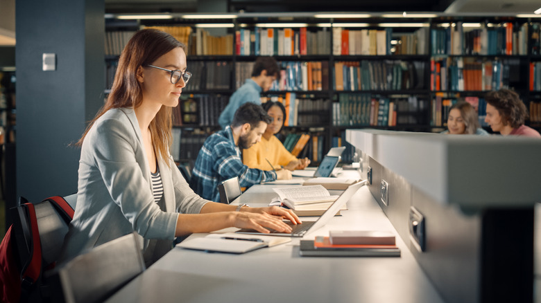 Woman researches in library