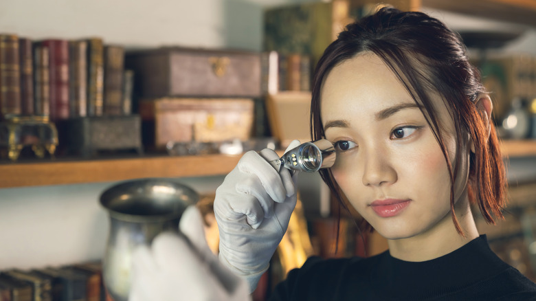 Woman apprasing item