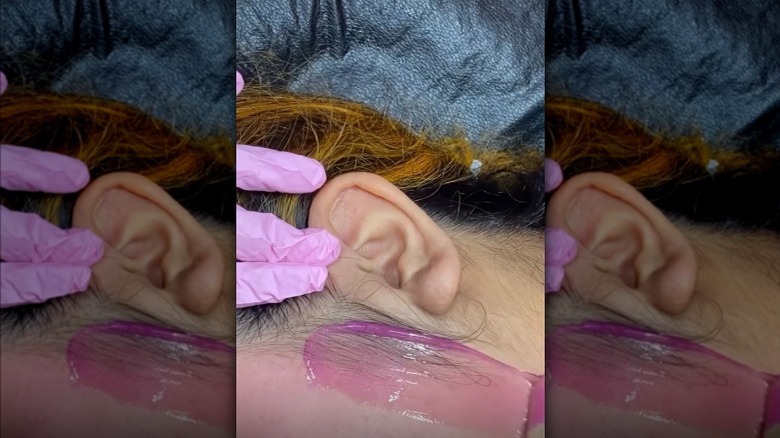 woman getting her sideburn waxed