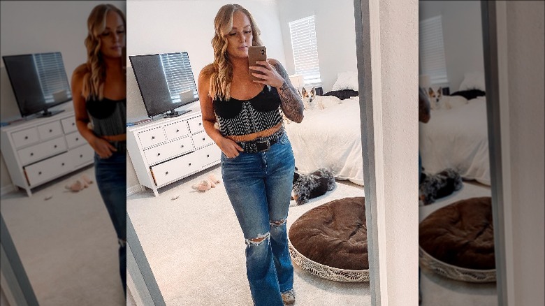 wearing distressed jeans