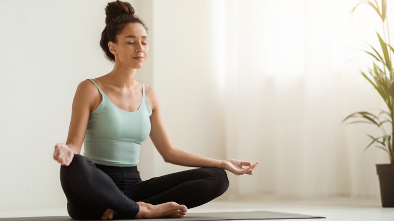 woman meditating on floor