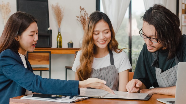 Friends studying together at cafe