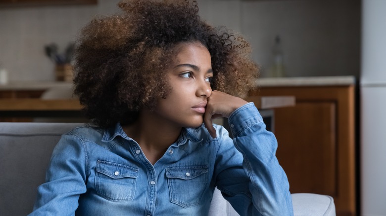 moody frustrated girl looking out window