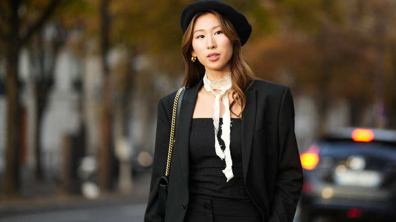 woman wearing black outfit and black beret