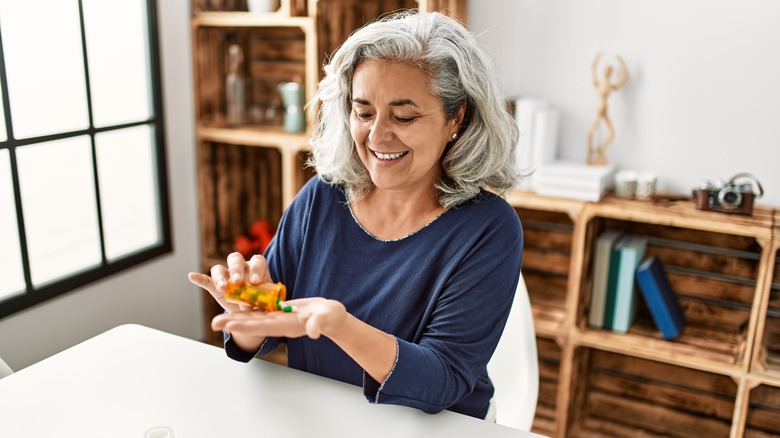 Happy woman takes medication 