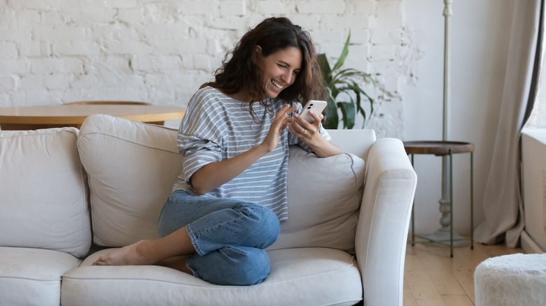 Woman watches video on phone 