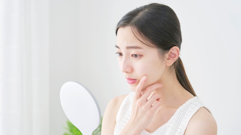 woman looking in mirror