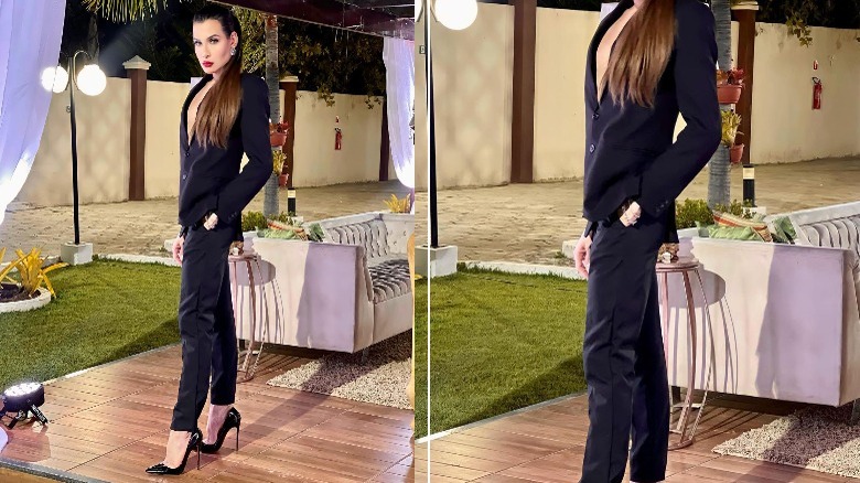 Woman models suit with stilettos