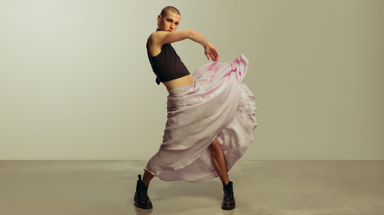 Androgynous model in flowing skirt