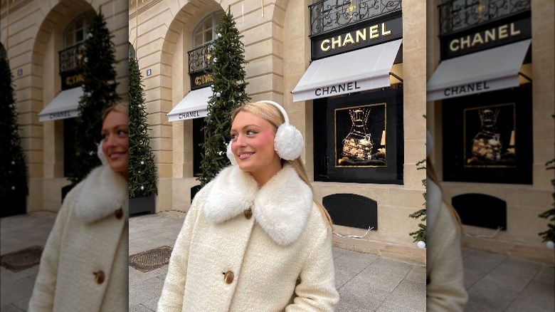 Girl wearing faux fur collar and earmuffs.