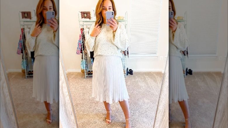 Girl wearing white flowy skirt.