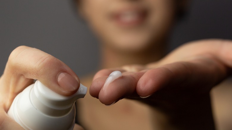 woman holding retinol product