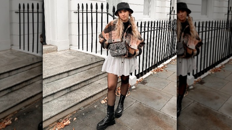 Woman in skirt tights boots