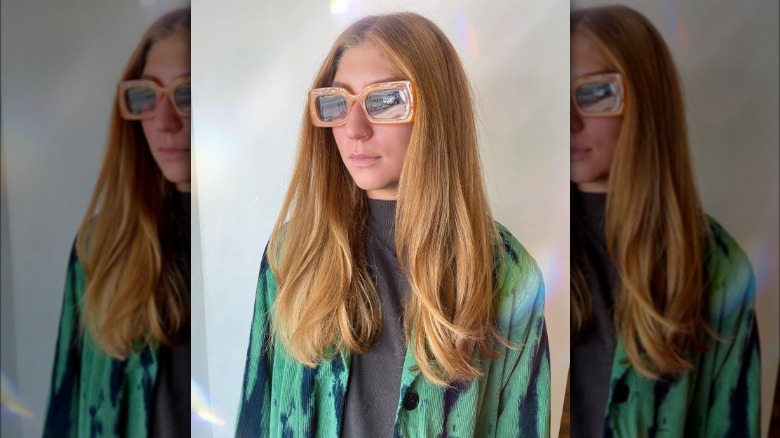 Woman poses in sunglasses