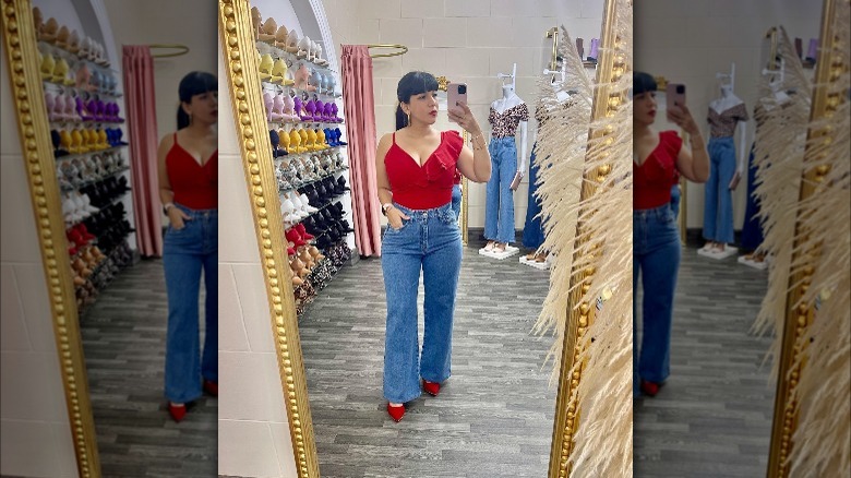 Woman wearing pointed-toe heels with flared denim.