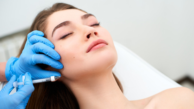 woman receiving needle in face