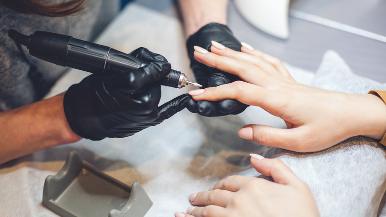 young asian woman getting manicure