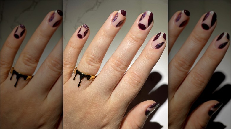 hand with gold dripping ring on finger