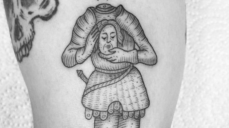 Woodcut tattoo of decapitated knight holding his head