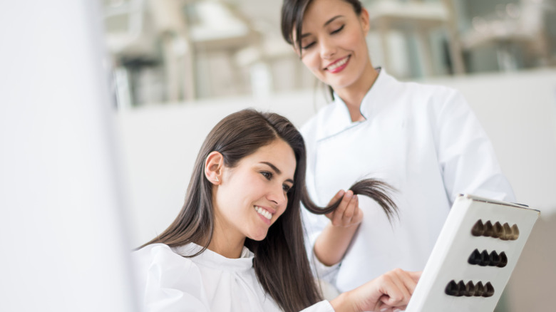 woman choosing hair color at salon