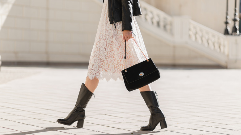 Woman in lace dress black boots 
