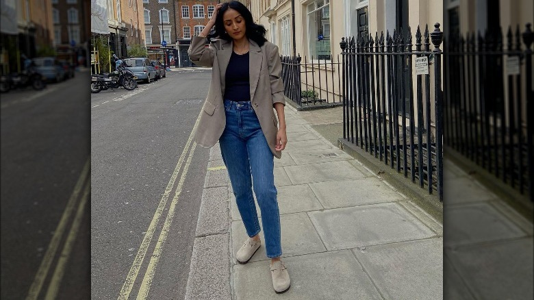 Woman in jeans, blazer, Birkenstocks
