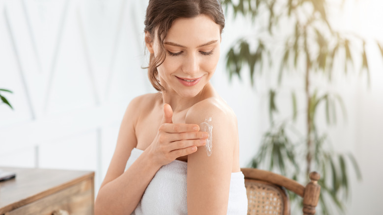 person moisturizing after shower
