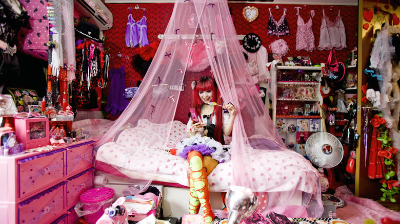 Woman sitting surrounded by possessions 