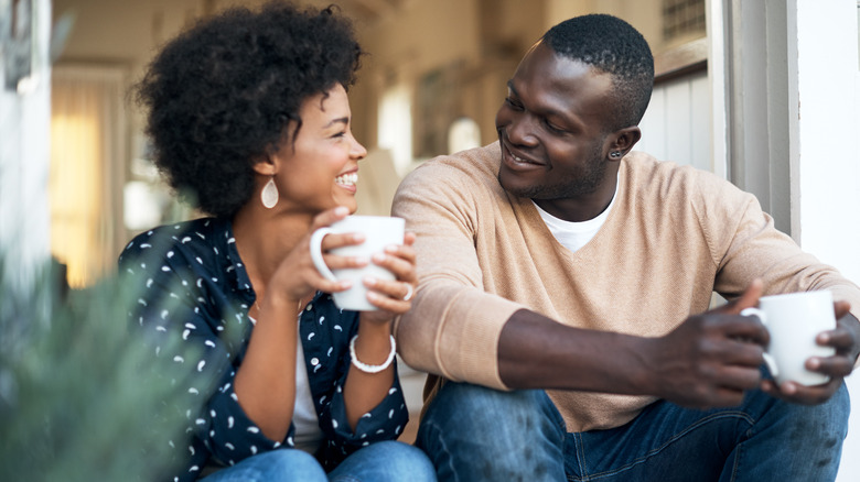 Woman, man talking, drinking coffee
