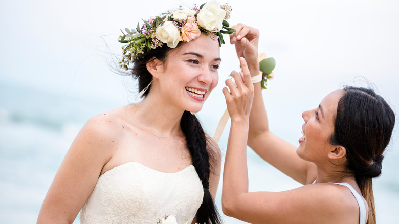 Maid of honor helping bride
