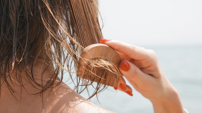 woman combing wet hair