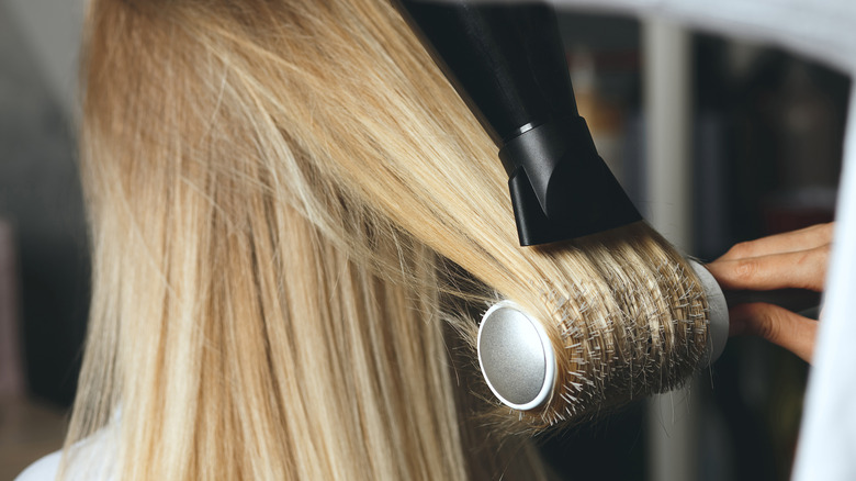 Woman using thermal hairbrush