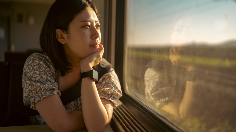 woman looking out window