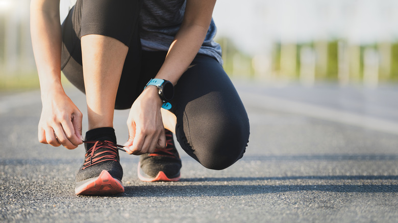 Woman tying her running shoes