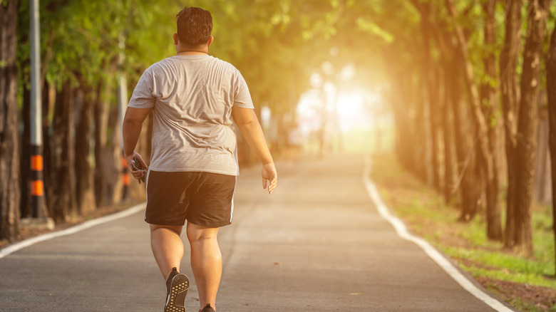 Man doing walk/run in park