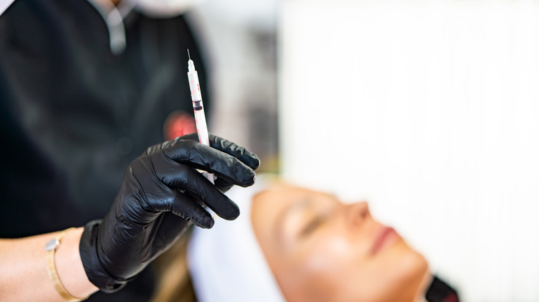 Doctor holding needle