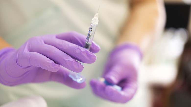 Doctor holding filler