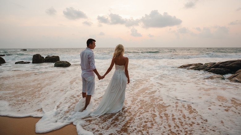 Couple getting married by the water