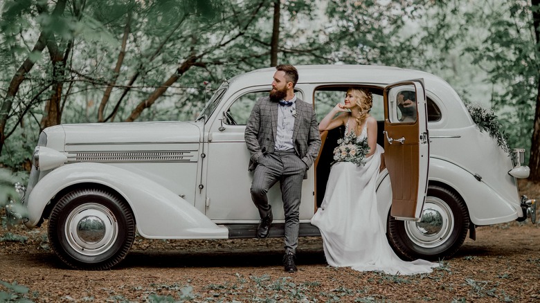 Bride and groom in a white car