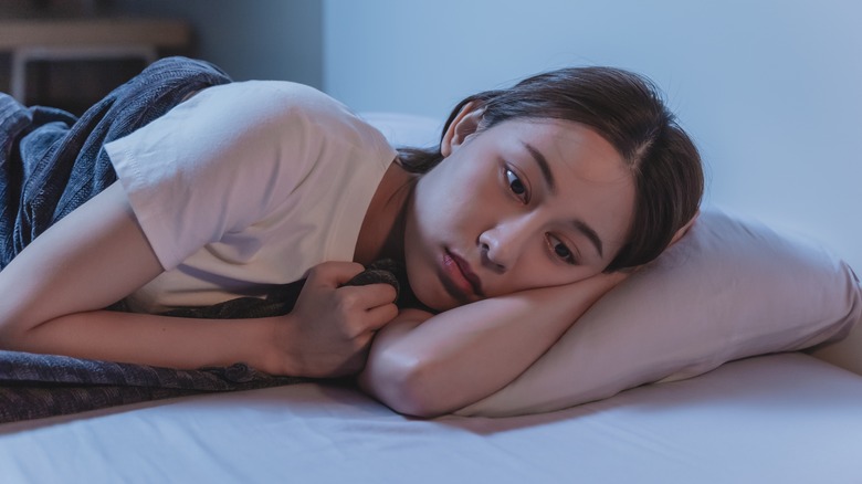 worried woman in bed