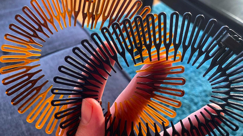 A person holding zigzag headbands